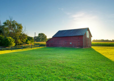 The red barn back-lit by morning sun