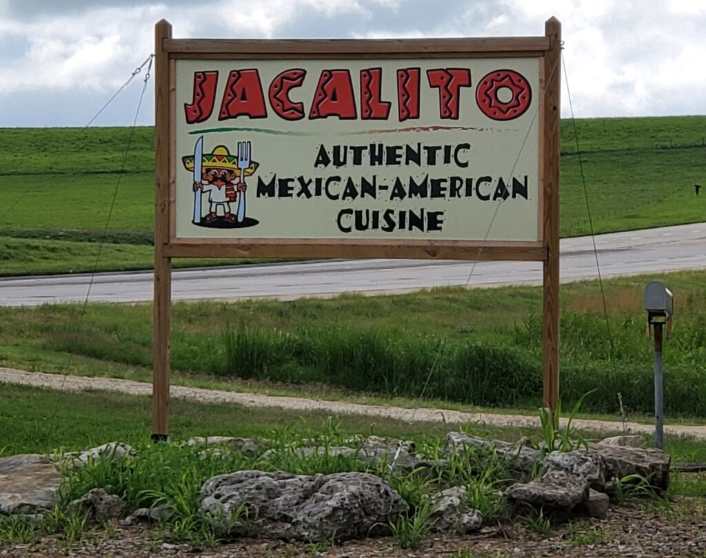 Street sign for the Jacalito Famly Restaurant in Strong City