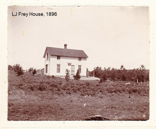 photo of white siding home with title "LJ Frey House, 1896"